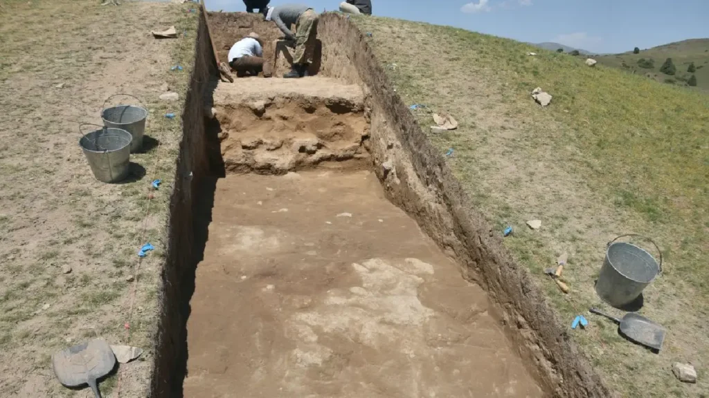 Archaeologist examining artifacts in Uzbekistan’s highlands